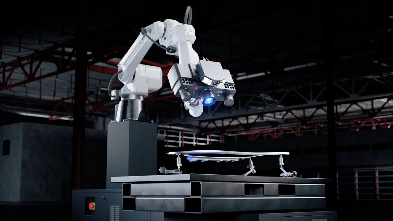 Roboterarm mit 3D-Scanner prüft ein Bauteil auf einem Messtisch.