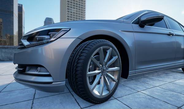 Nahaufnahme des linken Vorderrads und Radkastens eines silbernen VW Passat.